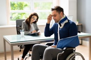 injured-man-in-a-wheelchair-talking-to-personal-injury-lawyer